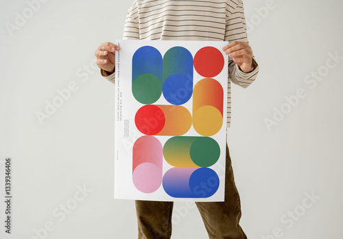 Mockup Of Man Holding Customizable Poster, Studio