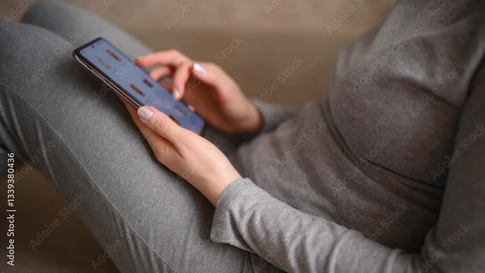 Ordering food using smartphone at home. Woman choosing drinks in online store using smartphone app while sitting on sofa at home, close up. Online food delivery. Ordering food using smartphone at home. Woman choosing drinks in online store using smartphone app while sitting on sofa at home, close up. Online food delivery.