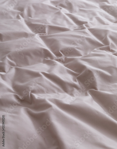 Bedroom: a duvet cover is stretched over a fluffy duvet with down cassettes. Close-up photo. Suitable for mockup