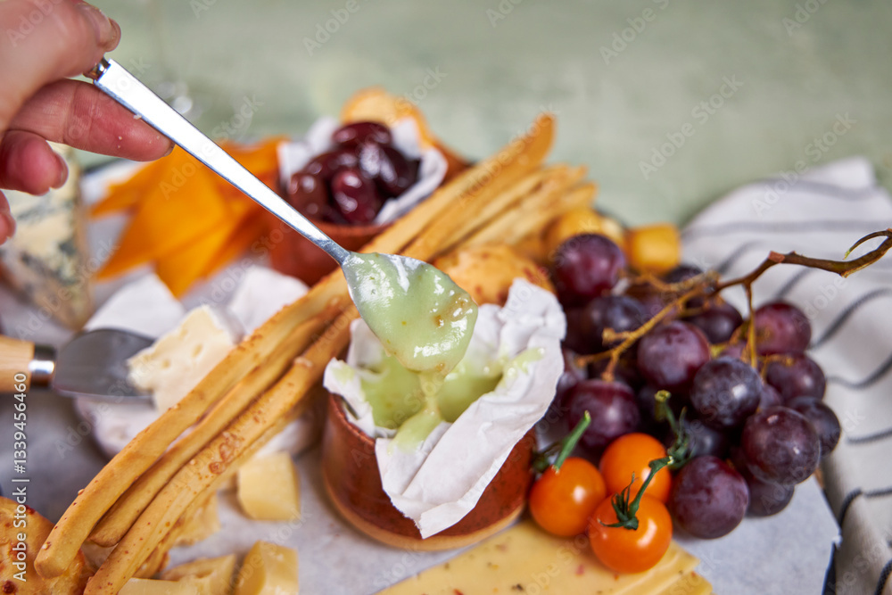 Close-up of a cheese plate with mild mold cheese, honey and olives Close-up of a cheese plate with mild mold cheese, honey and olives