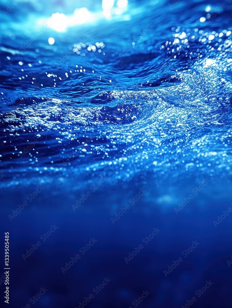 Underwater view of ocean waves with sunlight creating abstract patterns and deep blue gradient background Underwater view of ocean waves with sunlight creating abstract patterns and deep blue gradient background