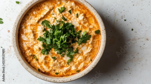 Spicy hot crab dip in cream bowl on countertop
