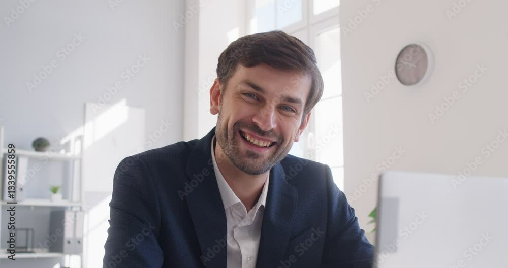 Portrait of a happy and successful Caucasian businessman in a professional suit working on a laptop in the office. Confidence, business skills, and expertise in audits and management. Portrait of a happy and successful Caucasian businessman in a professional suit working on a laptop in the office. Confidence, business skills, and expertise in audits and management.