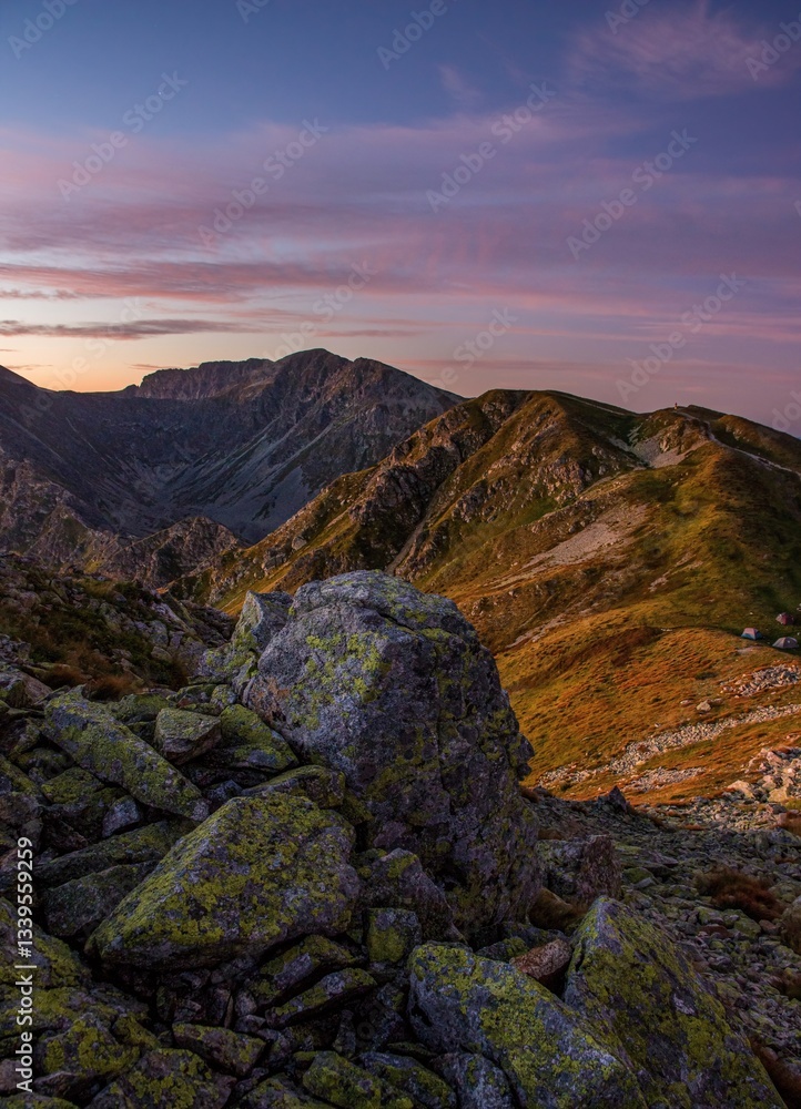 Obraz premium Sunrise from the ridge of the Western Tatras, Rohace (Roháče) overlooking the hill Salatin with a beautiful sky and grass lit by the rising sun. Tatry, Slovakia, Poland.