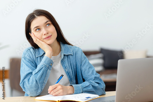 Obraz na płótnie Young woman thinking and writing at home w salonie