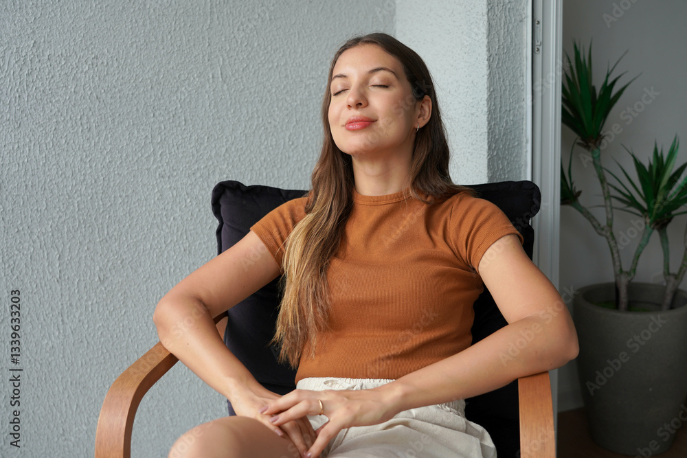 Relaxed young woman takes advantage of a warm day to take a nap on her balcony