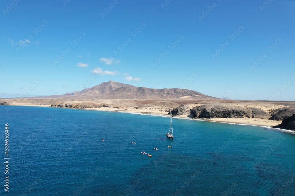 Obraz premium Aerial panorama of LANZAROTE coastline with beaches and volcanic mountains near National Park area of Canary Islands near Playa Blanca