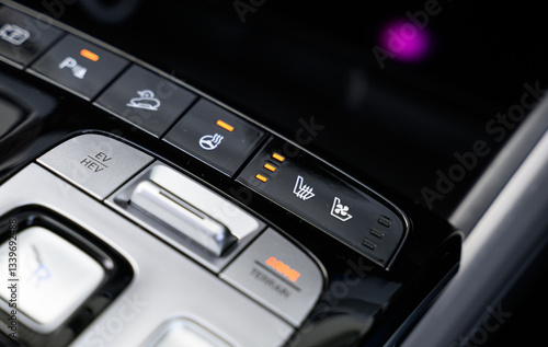 Heated seats controls with heated steering wheel and ventilated seats, the buttons for seat warmers are lit up
