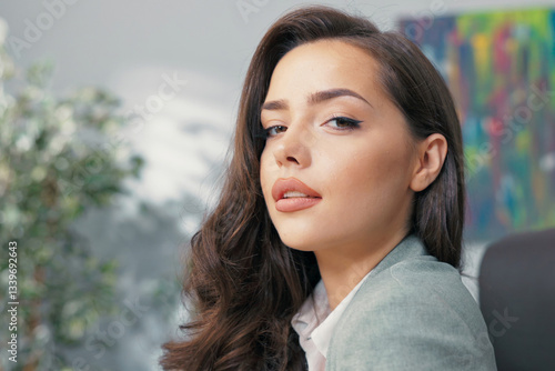 Fotografie Beautiful boss manager accounting worker secretary in office sits in front of la
