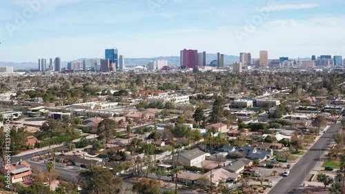 Aerial drone view of Las Vegas city skyline with residential homes and trees 10