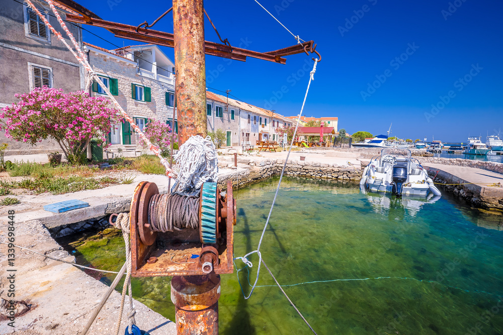 Croatia. Colorful harbor and rusty boat ramp of Krapanj island, sea sponge harvesting village