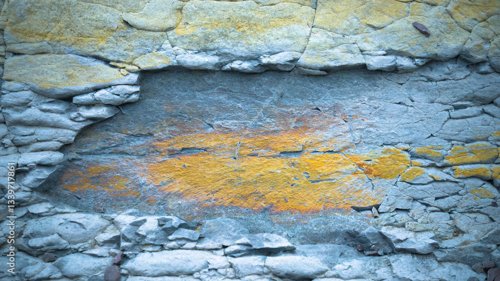 Fototapeta premium Close-up of a textured rock surface with layers of cracked stone. 