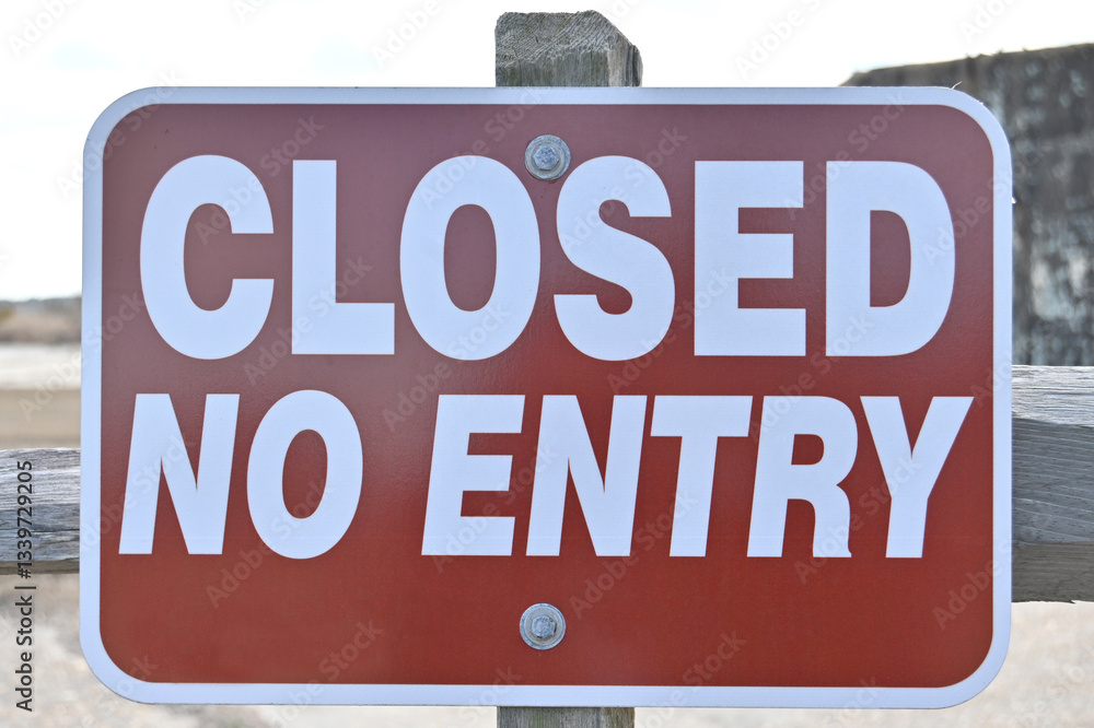 Red and white Closed No Entry restriction sign on post with background Red and white Closed No Entry restriction sign on post with background
