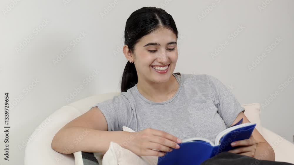 Woman sitting on sofa indoor reading textbook increase knowledge about social and technology for occupation or raise children to be good adult as smart mother. Lifelong learning concept. Divergence. Woman sitting on sofa indoor reading textbook increase knowledge about social and technology for occupation or raise children to be good adult as smart mother. Lifelong learning concept. Divergence.