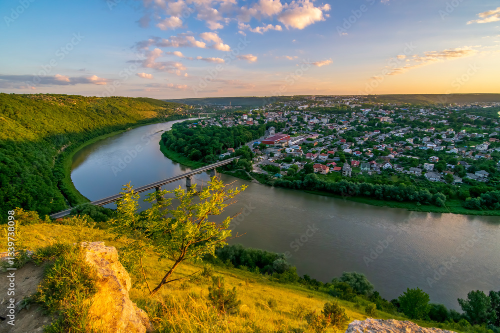 Aerial view of Zalishchyky town with bridge over Dniester river canyon at sunset, Ternopil region, Ukraine Aerial view of Zalishchyky town with bridge over Dniester river canyon at sunset, Ternopil region, Ukraine