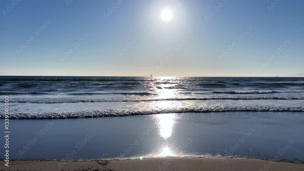 A beautiful and tranquil beach scene that captures the suns stunning reflection on gentle ocean waves A beautiful and tranquil beach scene that captures the suns stunning reflection on gentle ocean waves