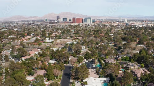 Aerial drone view of Las Vegas city skyline with residential homes and trees 15