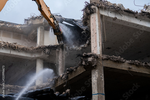 Demolition of a concrete building with machinery in action