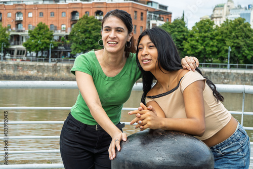 Two smiling tourist friends enjoying a day in buenos aires, argentina