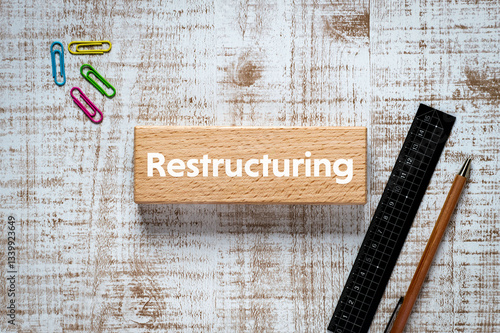 Fotografija There is wood block with the word Restructuring