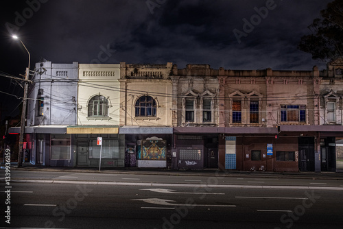Urban scene with old terrace house and closed store front