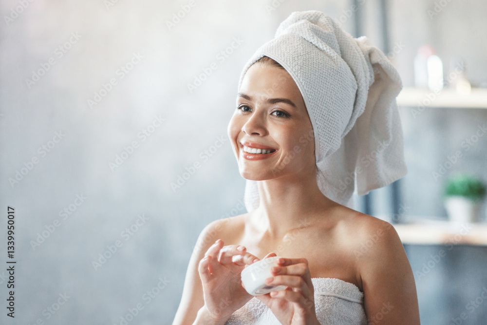 Cosmetology and skin care. Attractive girl with facial cream in front of mirror at bathroom Cosmetology and skin care. Attractive girl with facial cream in front of mirror at bathroom