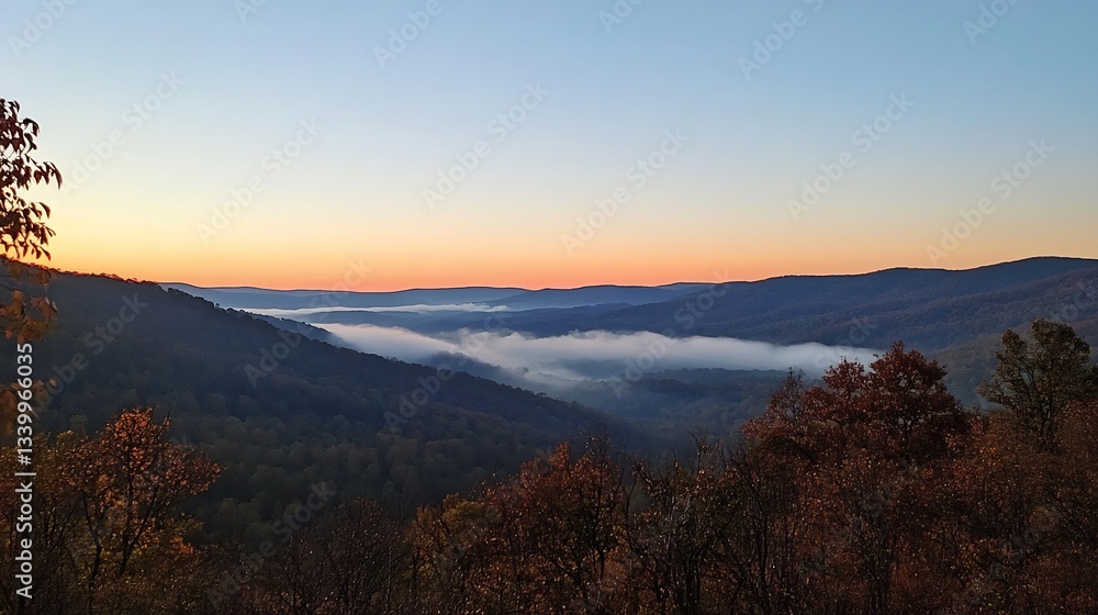 A peaceful sunrise over the mountains with mist in the A peaceful sunrise over the mountains with mist in the