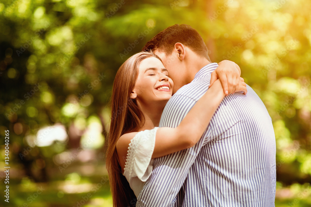 Tender couple embracing, bonding to each other at summer park on bright day. Blank space Tender couple embracing, bonding to each other at summer park on bright day. Blank space