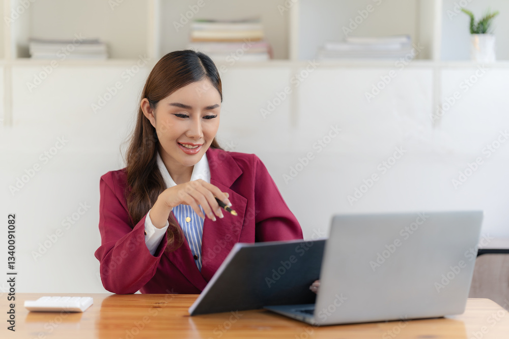 Beautiful business Asian woman with suit working at office table using laptop computer with copy space. Businessman, freelance employee, online marketing Beautiful business Asian woman with suit working at office table using laptop computer with copy space. Businessman, freelance employee, online marketing