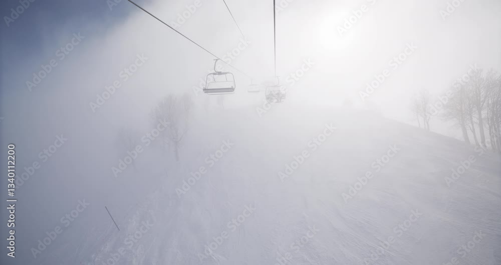 POV on snowy mountain ski lift with thick fog POV on snowy mountain ski lift with thick fog