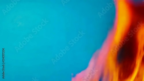 Vibrant flames against a blue background creating a striking visual contrast