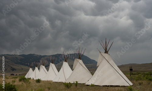 Obraz na płótnie Seven Teepees Fill The Frame Below Storm Clouds w salonie