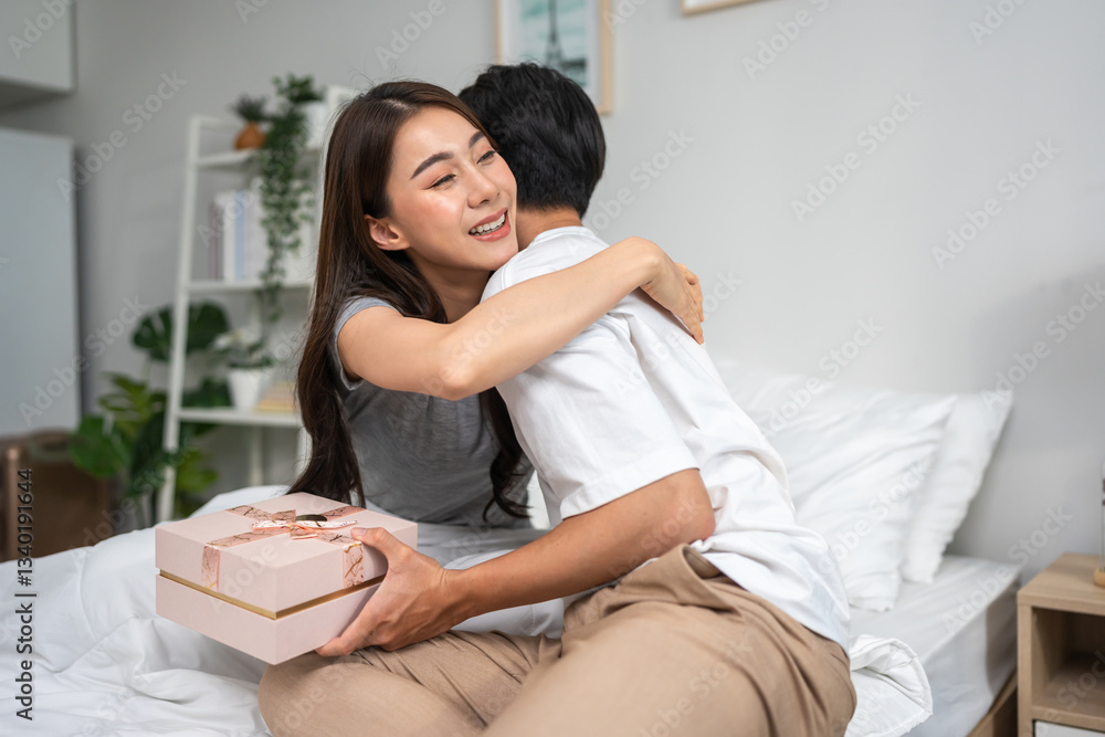 Asian handsome man receive birthday present gift box from girlfriend. Asian handsome man receive birthday present gift box from girlfriend.