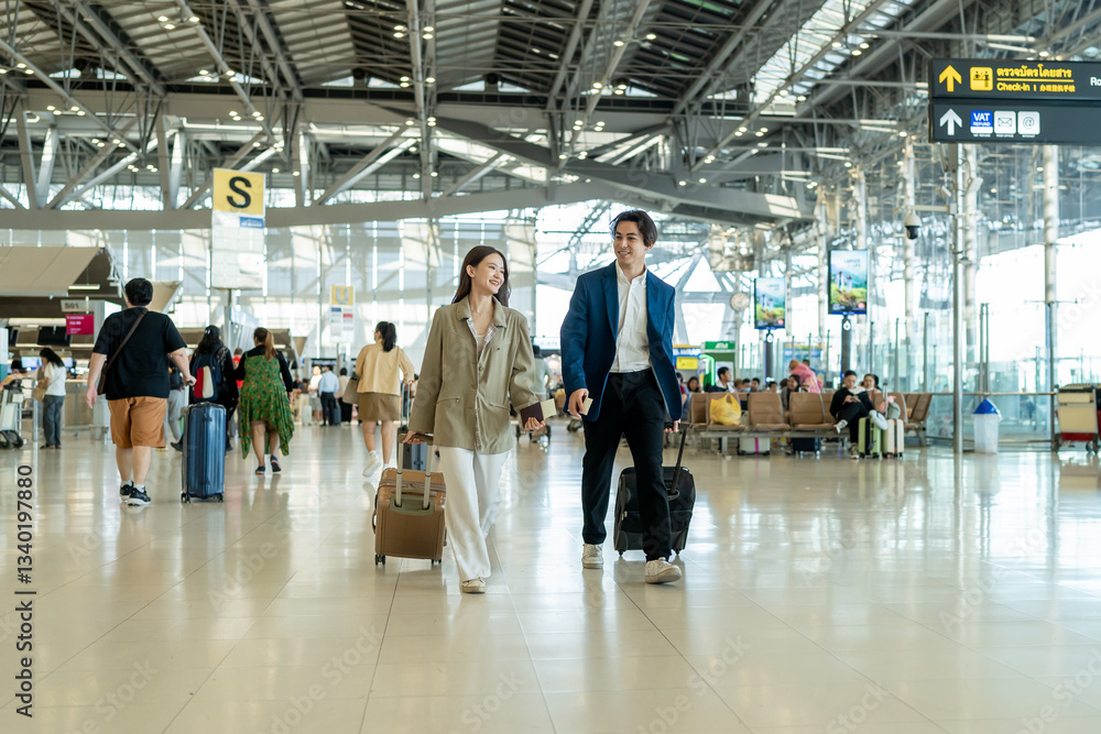 Fototapeta premium Asian businessman and woman walking in airport terminal to boarding gate. 