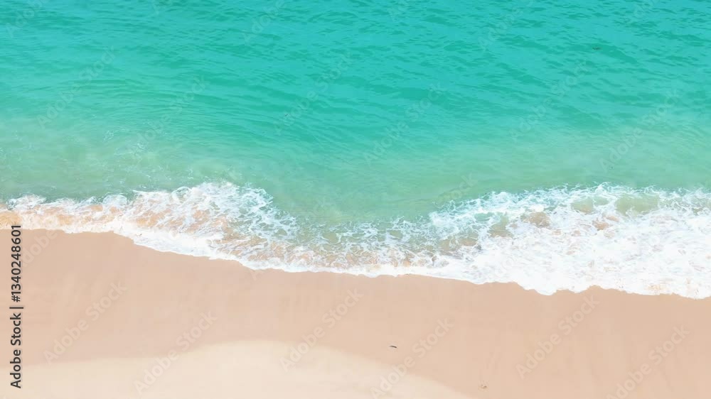 Aerial view of the turquoise waves gently crashing onto the white sands Aerial view of the turquoise waves gently crashing onto the white sands
