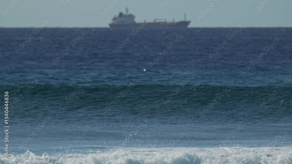 Solitary cargo ship in Indian Ocean and waves. Distant seascape. Maldives Solitary cargo ship in Indian Ocean and waves. Distant seascape. Maldives