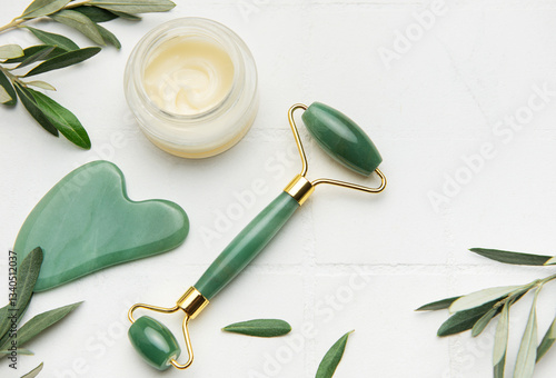 Obraz na płótnie Gua sha stone, face roller and cream promoting skin care and relaxation w salonie
