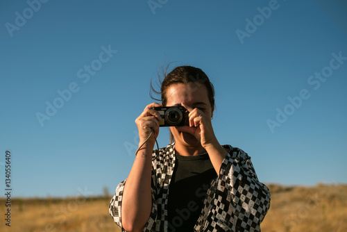 Smiling woman holding a digital camera in Cappadocia photo