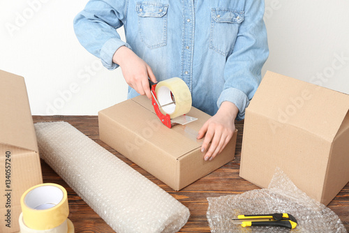 Woman packing cardboard box...