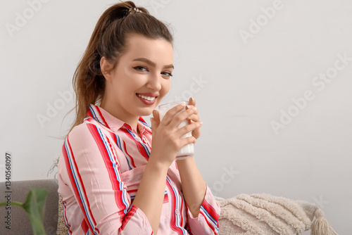 Young woman with glass of m...