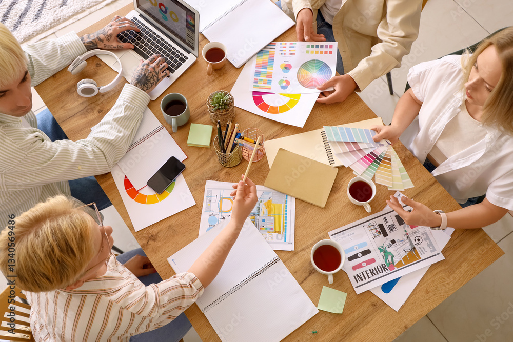 Fototapeta premium Team of graphic designers working with color palettes at table in office