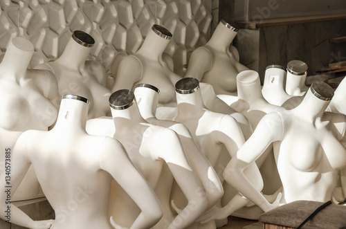 Photography lots of headless plastic mannequins in the store's warehouse