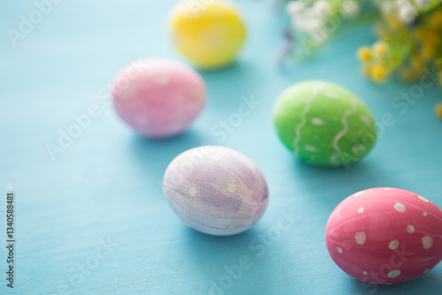 Colorful easter decoration with and flowers on gray wooden table. Top view