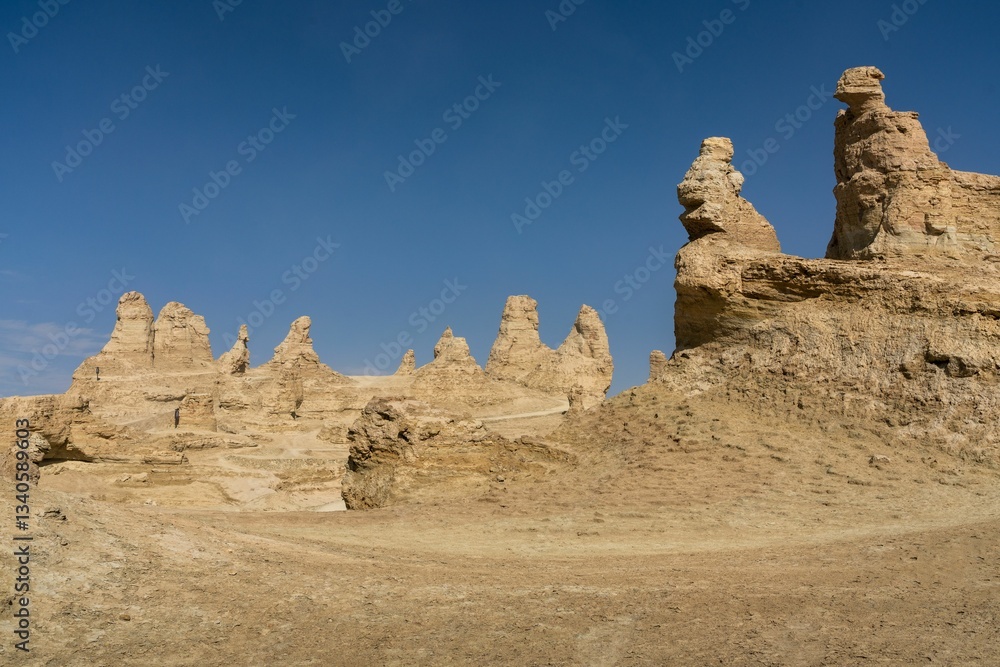 Fototapeta premium Desert rock formations under a blue sky.