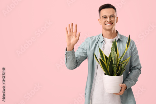 Handsome man with plant wav...