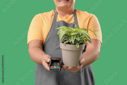 Mature gardener with plant ...