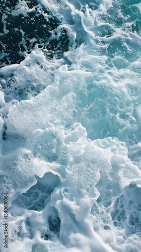 Aqua marine surface with foamy sea water and air bubbles, creating textured patterns with dynamic motion and gentle seafoam on the ocean