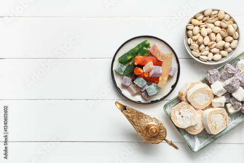 Wallpaper Mural Composition with traditional Eastern sweets and Aladdin lamp for Ramadan on light wooden background Torontodigital.ca