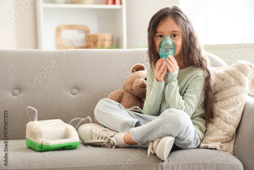 Little girl using nebulizer...