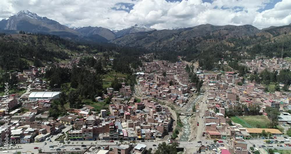 Drone shot of Huaraz, Peru, showcasing a picturesque Andean city surrounded by mountains, with a winding river and urban-rural contrast. Ideal for travel, culture, and nature-related projects Drone shot of Huaraz, Peru, showcasing a picturesque Andean city surrounded by mountains, with a winding river and urban-rural contrast. Ideal for travel, culture, and nature-related projects